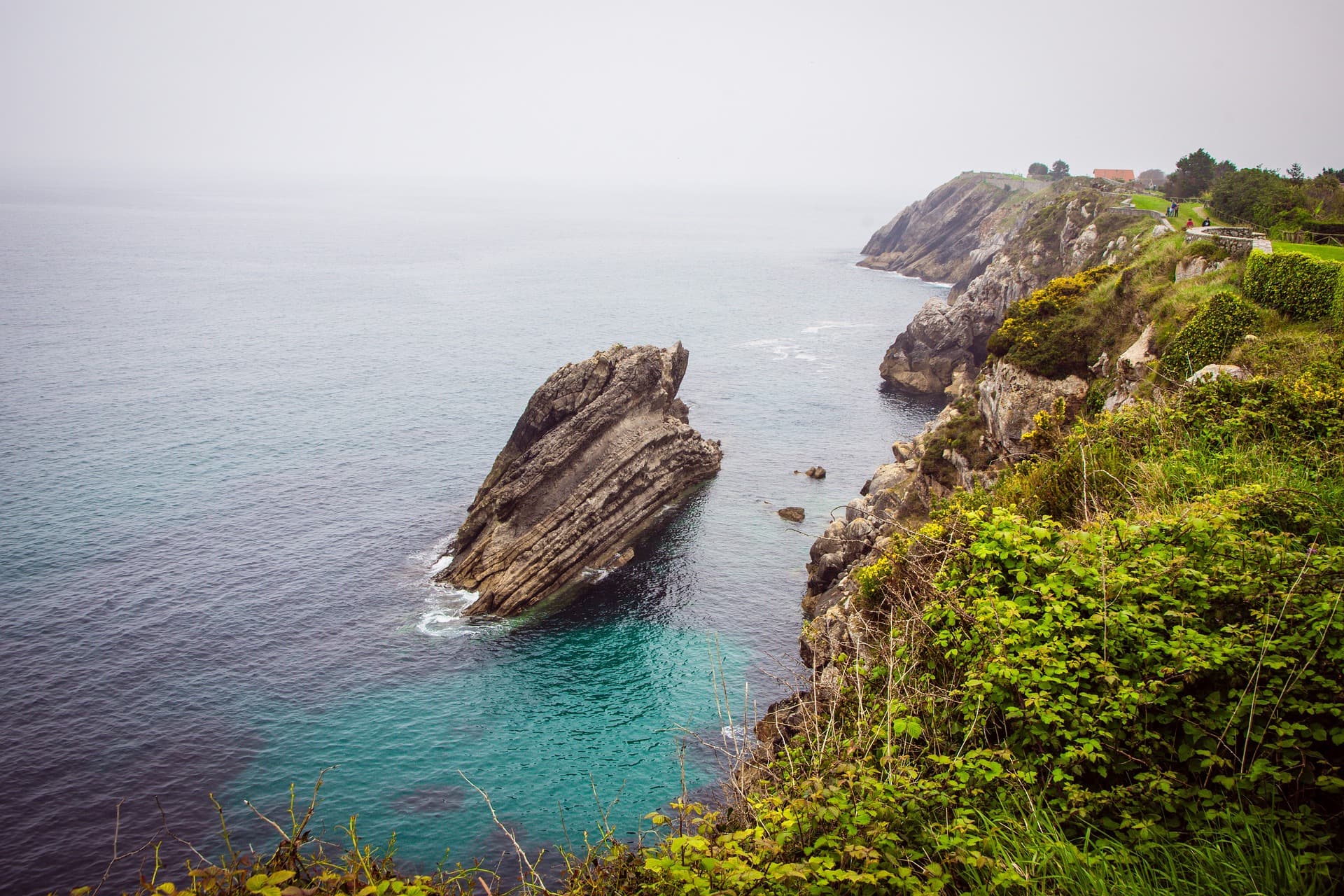 Llanes on the green coast, where a rain jacket earns its place in July
